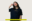 Musician Mine is wearing our More Humanity at Sea T-Shirt in navy/yellow